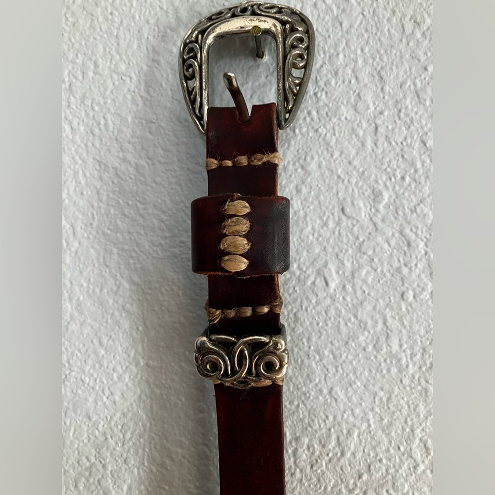 Brown leather western belt with silver-tone engraved buckle